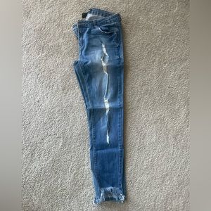 Distressed jeans with fringe ankle